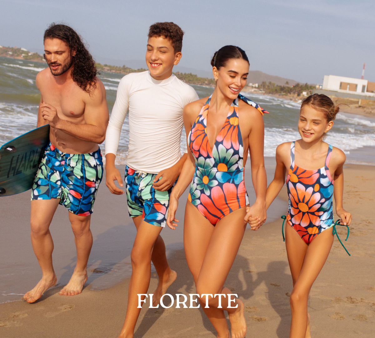 FAMILY AT THE BEACH WEARING MATCHING SWIMSUITS