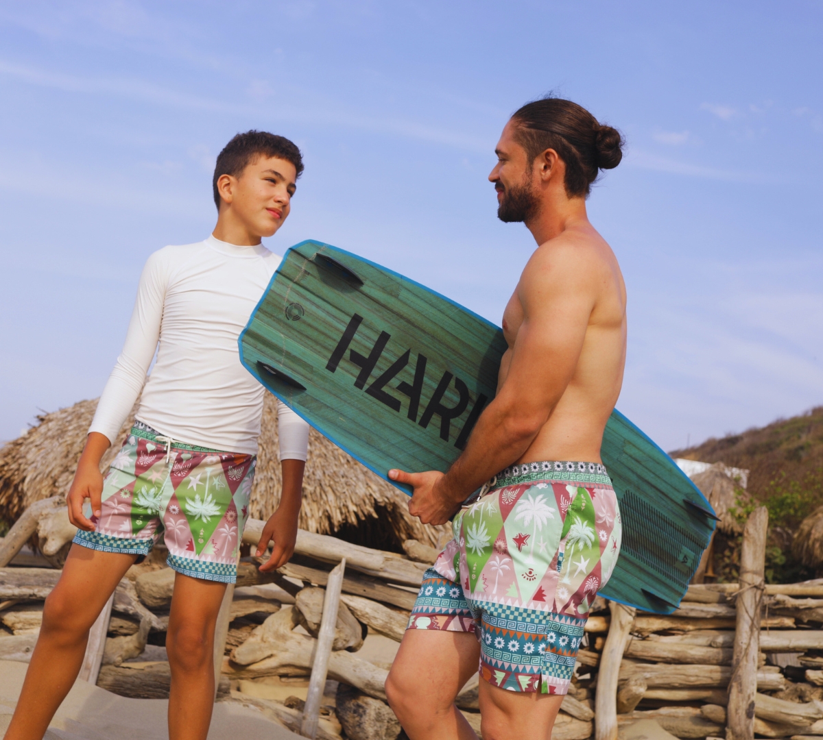 father and son wearing matching swim trunks from laino swimwear
